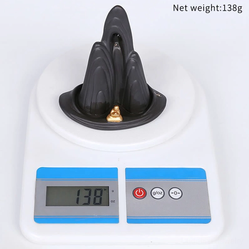 Purple ceramic backflow incense burner with peaceful monk statue and flowing smoke cascade design