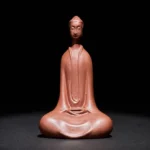 Purple clay Buddha meditation statue front view, handcrafted serene desktop decoration