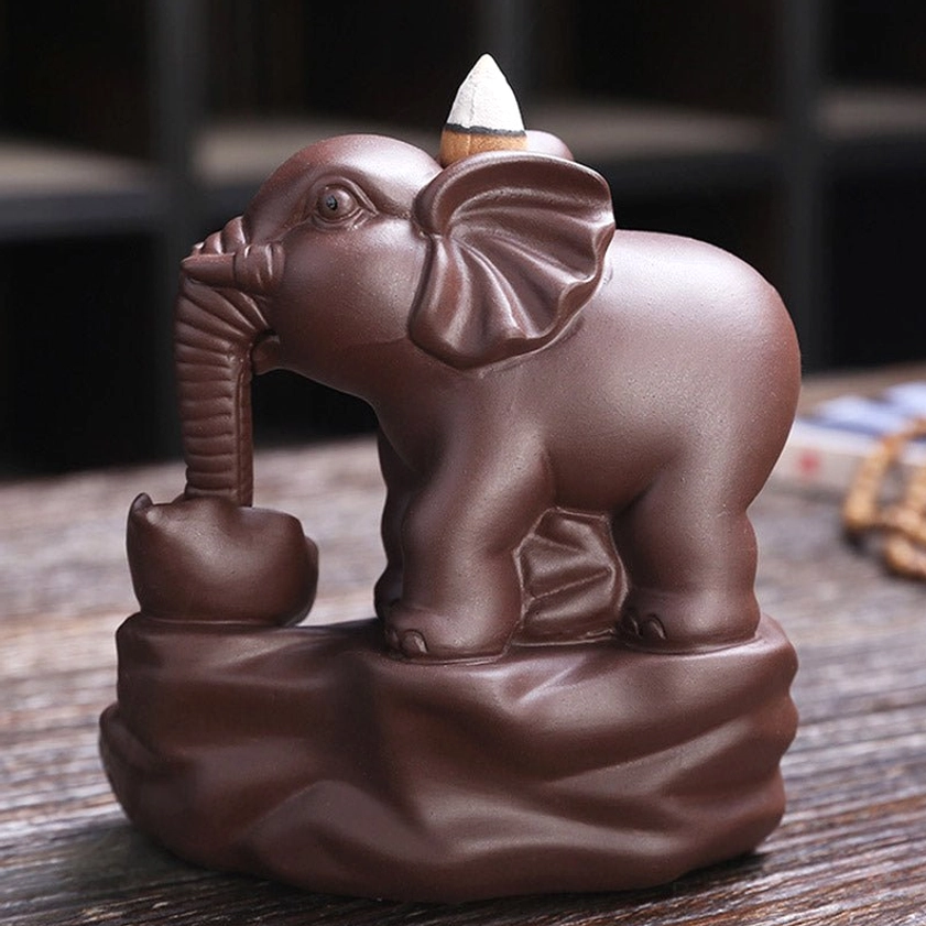 Single elephant purple clay backflow incense burner with rock base, side profile view