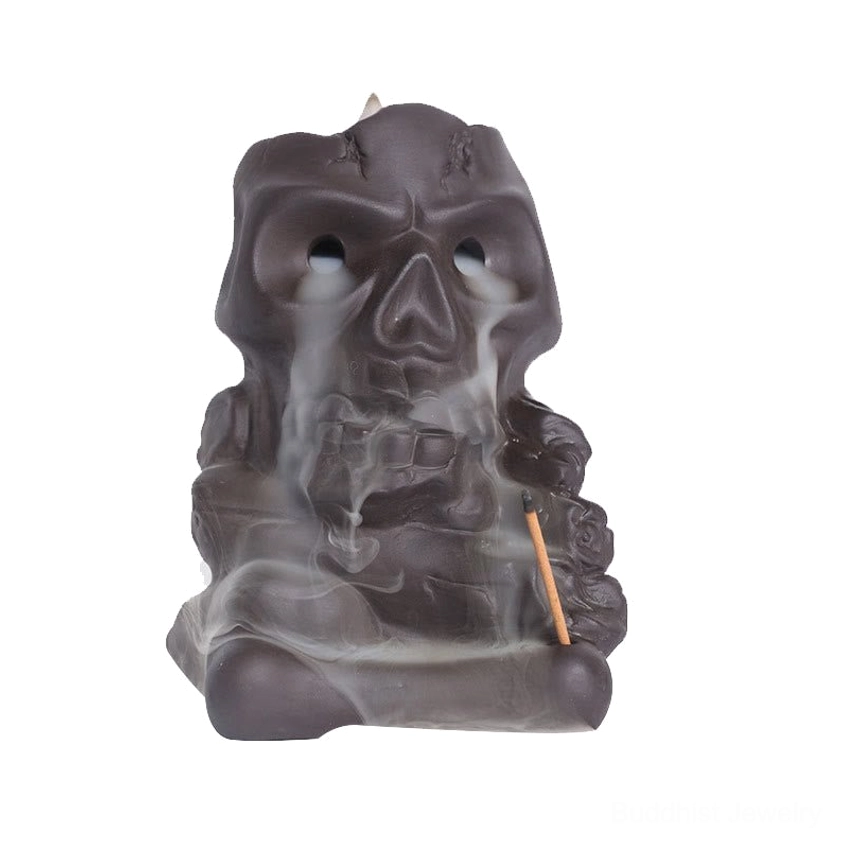 Skull backflow incense burner front view with waterfall smoke effect and clear white background