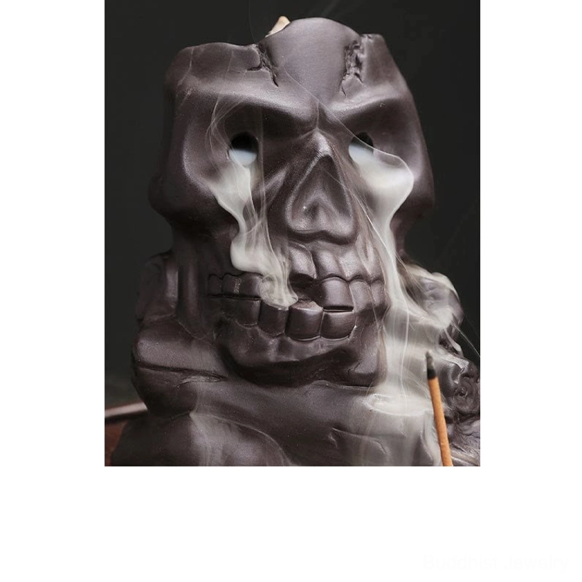 Front direct view of purple clay skull backflow incense burner with detailed facial features and flowing smoke