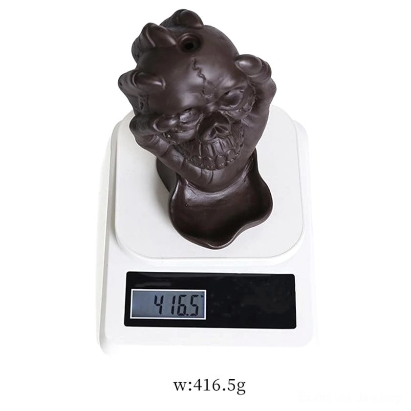 Handcrafted purple clay skull incense holder - showing size reference and natural material texture