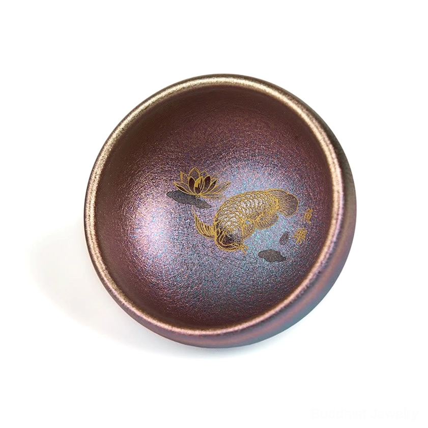 Purple gold color Jianzhan handmade tea cup koi fish pattern detail shot close-up