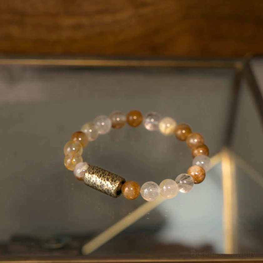 Multi-crystal bracelet featuring purple phantom stones on neutral background