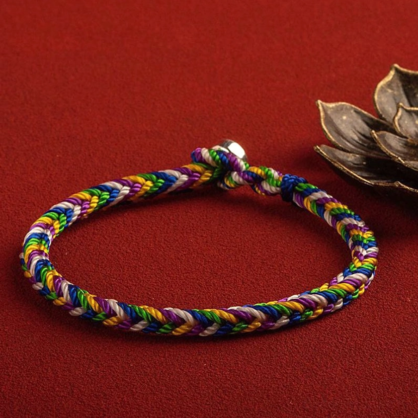 Rainbow five-color Buddhist lucky bracelet close-up showing detailed braided weave and spiritual symbolism