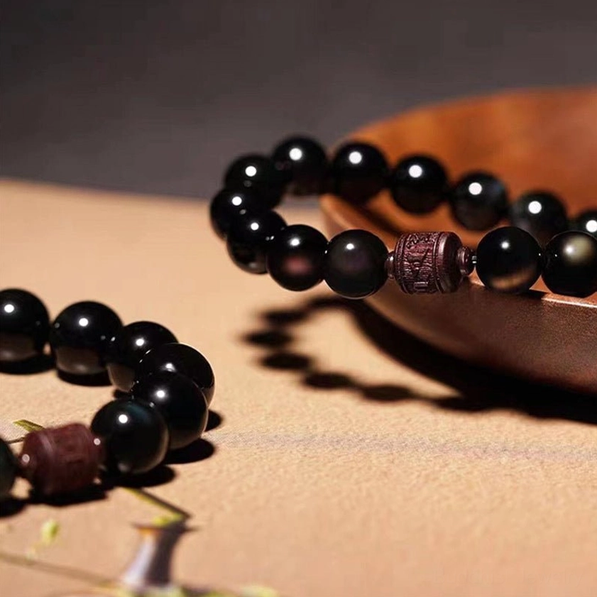 Rainbow obsidian beads showing color variations and natural inclusions from magnetite nanoparticles
