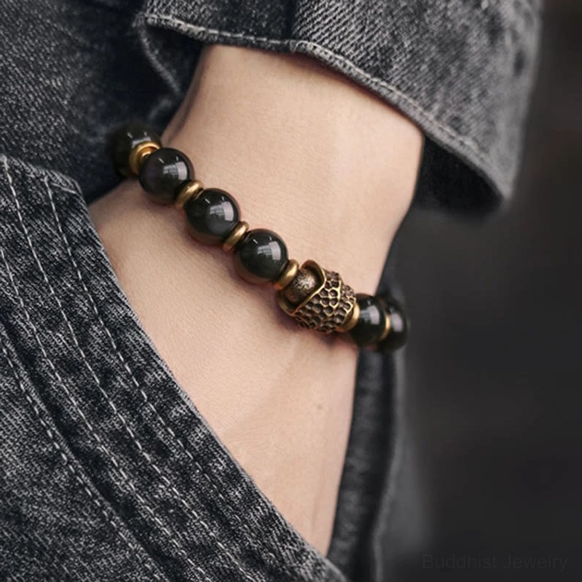 Rainbow obsidian copper bracelet worn on wrist with denim, minimalist single-strand design for casual daily spiritual wear and meditation