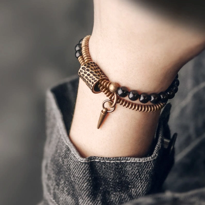 Rainbow obsidian double layer bracelet worn on wrist with denim cuff, showing two-layer beaded design