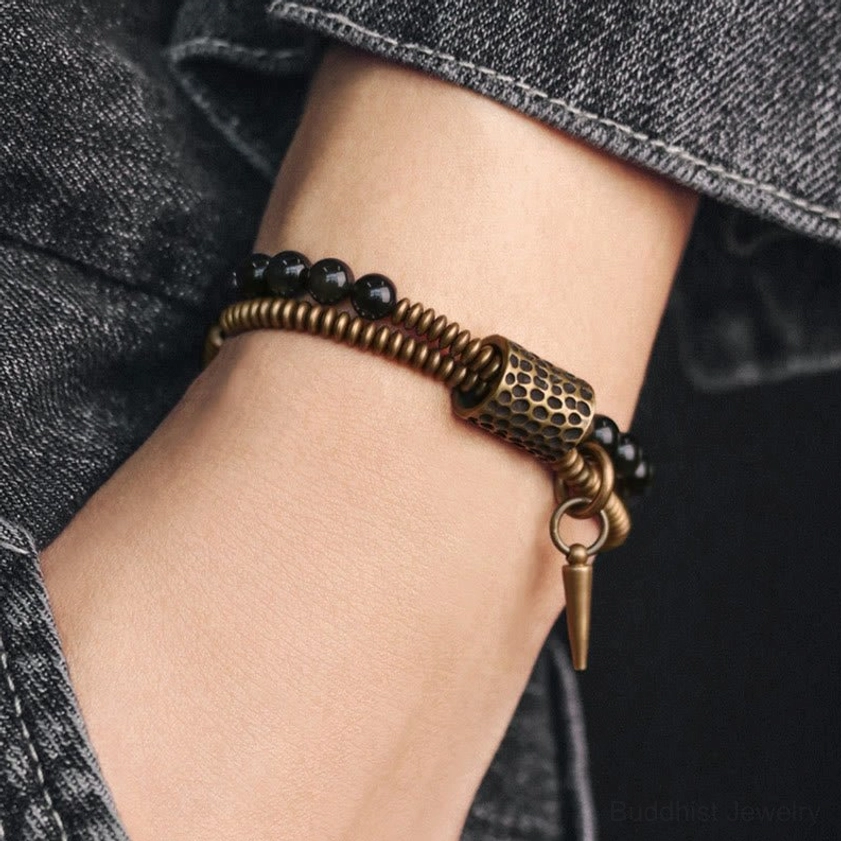 Rainbow obsidian double layer bracelet worn on wrist with denim, showing comfortable fit and bronze spike charm