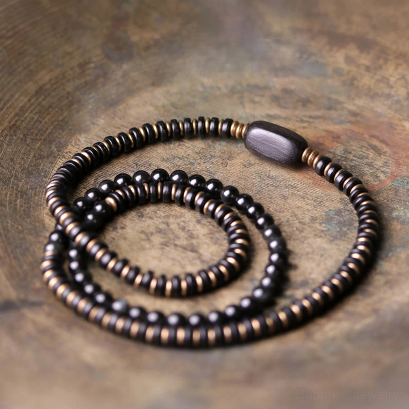 Triple wrap bracelet with rainbow obsidian and ebony wood combination, displaying multi-layer design with spiritual healing properties