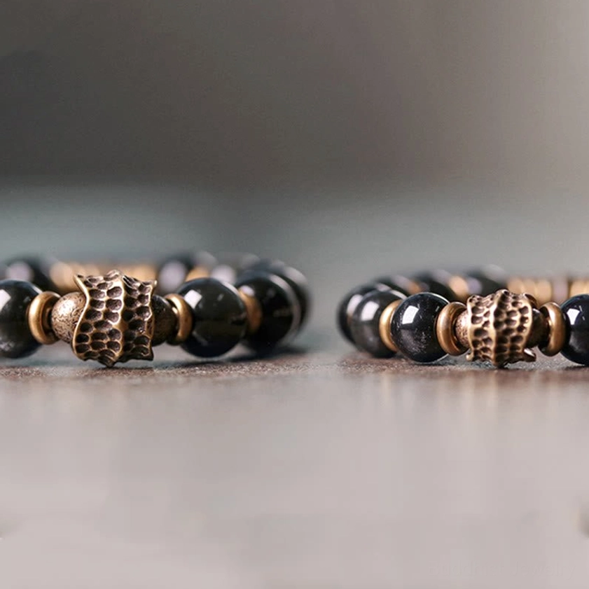 Two matching rainbow obsidian bracelets with carved bronze focal beads, handmade Buddhist healing jewelry for couples or gift sets