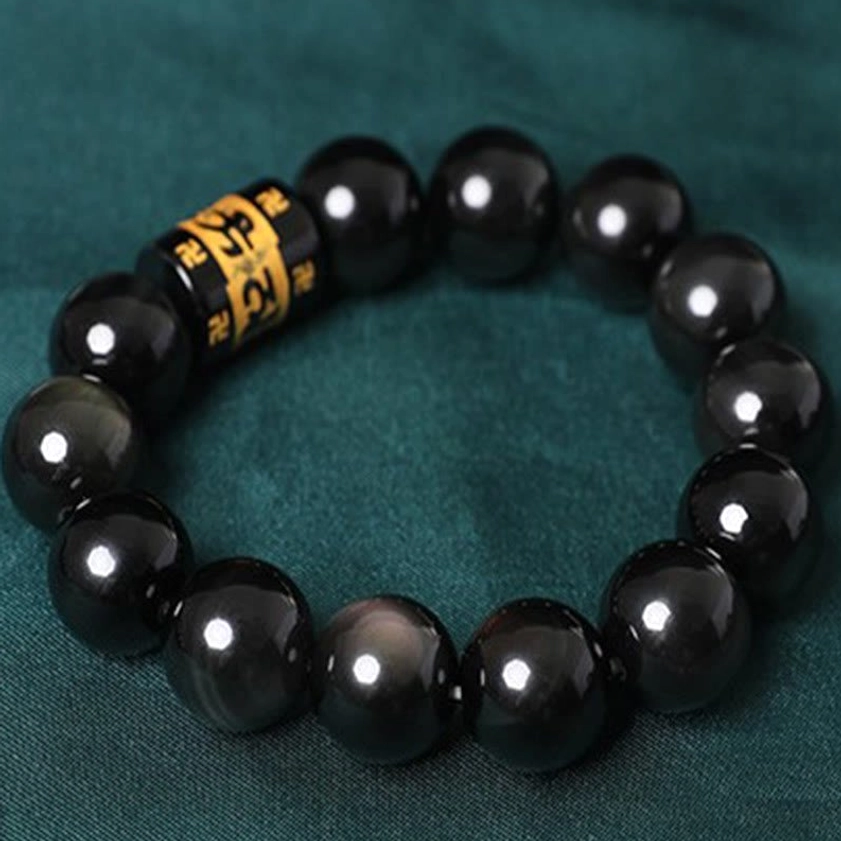 Rainbow obsidian Buddhist bracelet detail shot - smooth round beads and golden mantra engravings