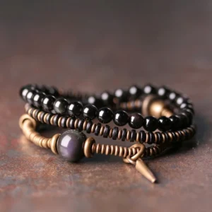 Triple wrap rainbow obsidian healing bracelet with ebony wood and copper, featuring multi-layer twisted design and cone pendant on rustic tabletop