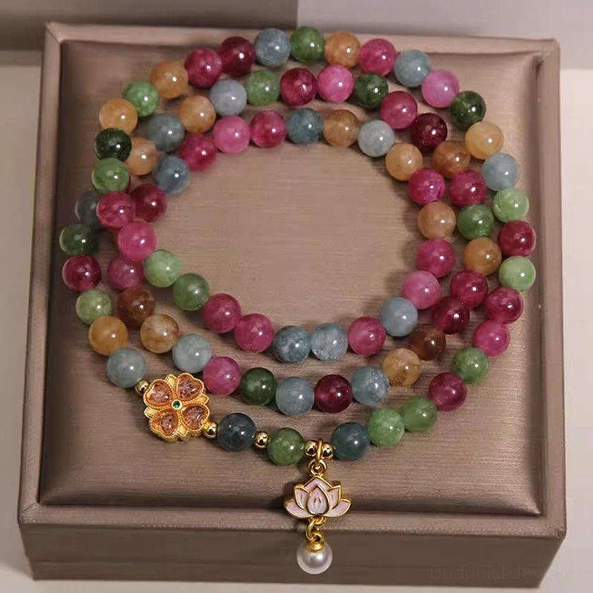Colorful tourmaline beaded triple wrap bracelet overhead flat lay view with lotus charm