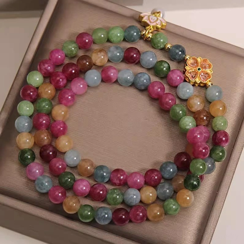 Multi-strand rainbow tourmaline bracelet with assorted colored beads and gold clasps