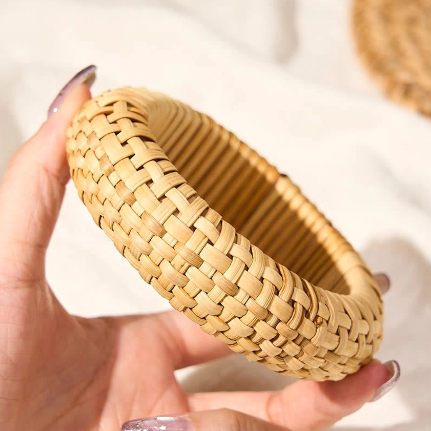 Rattan grounding bangle bracelet held in hands showing craftsmanship detail and comfortable fit for daily wear