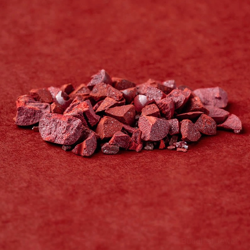 Raw cinnabar stone chunks showing natural deep red matte texture before bead carving