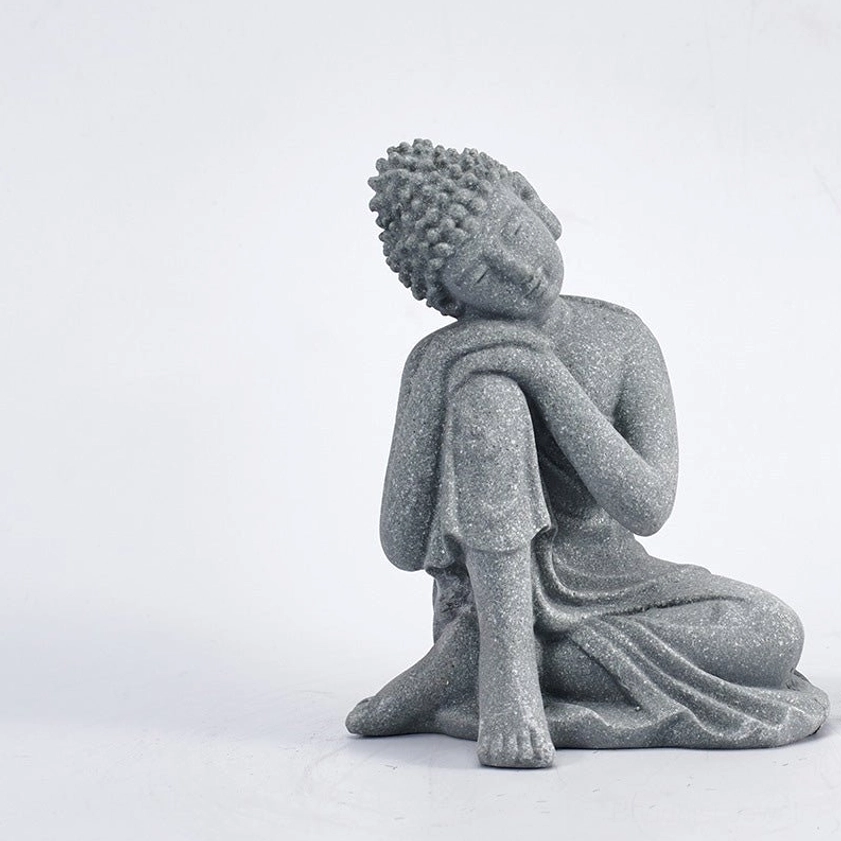 Reclining meditation Buddha statue with resting pose, grey matte sandstone finish, right three-quarter angle on white background
