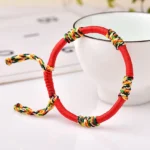 Red adjustable King Kong knot Buddhist bracelet with colorful woven knots and braided rope tail for protection and good fortune