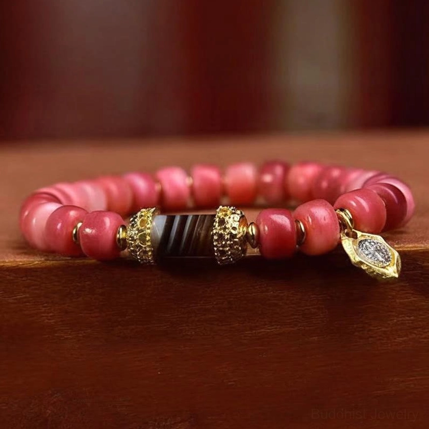 Red agate Buddhist bracelet side view showing dzi bead metal accents and bead assembly