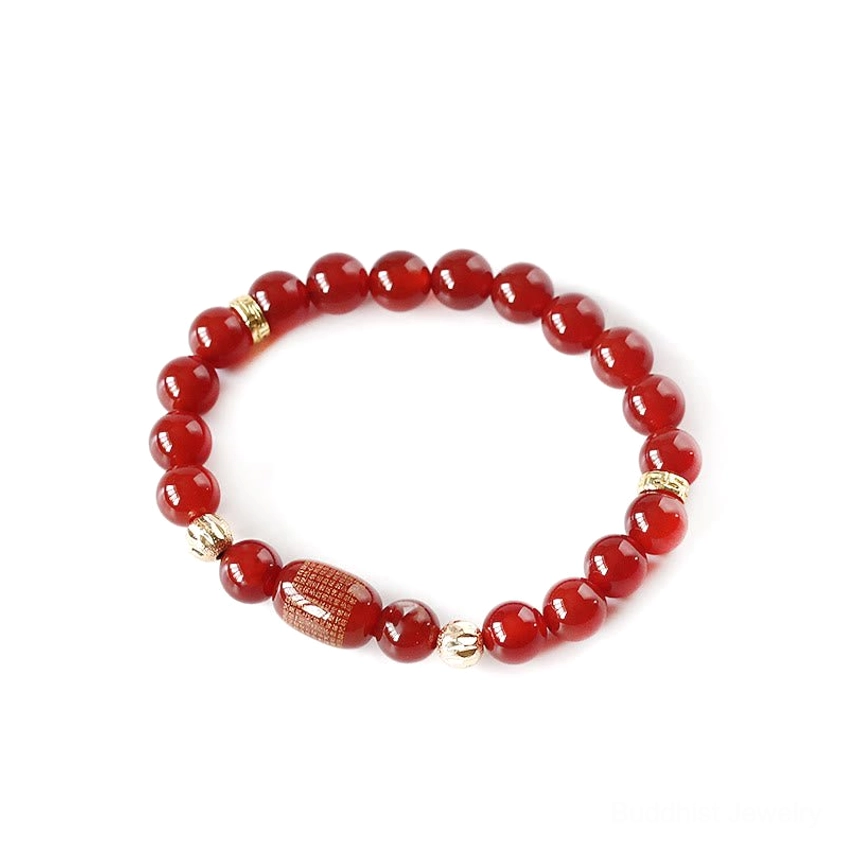 Red agate round beads with engraved red barrel bead and metal spacers on white background, premium flat lay shot