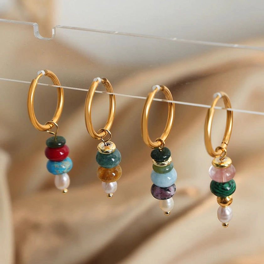 Red agate pearl dangle earrings with titanium steel hooks displayed in flat lay - Buddhist confidence stone jewelry