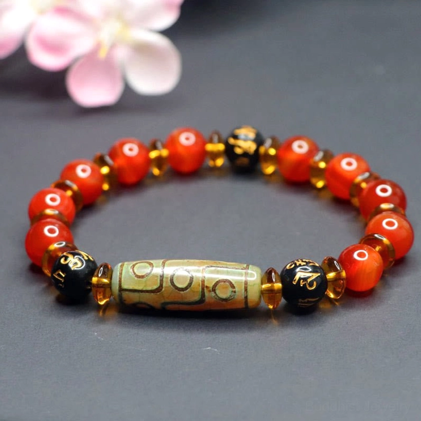 Handcrafted red agate dzi bead bracelet with authentic vintage-aged nine-eye center stone