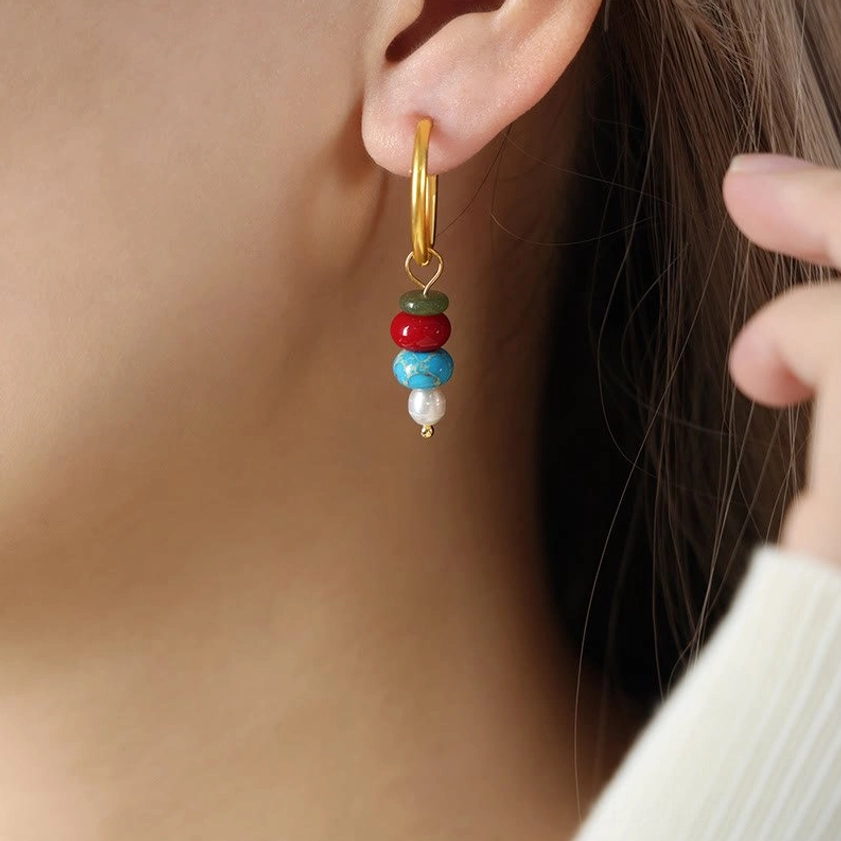 Red natural stone agate earrings worn close-up on neck - showing detail of layered stone and pearl design
