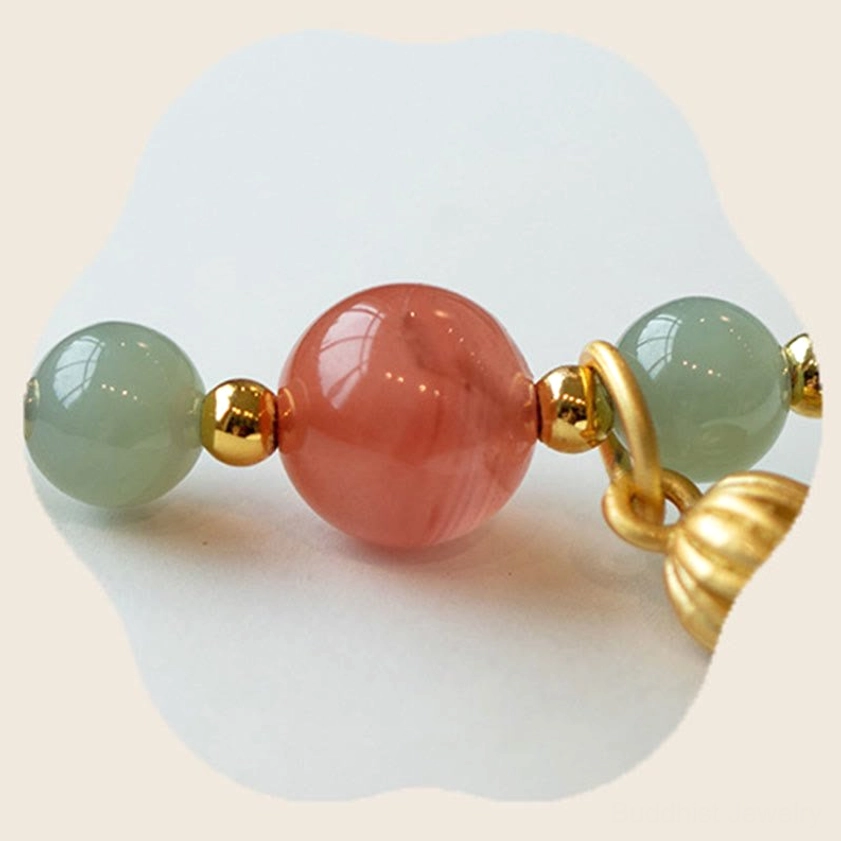 Red agate and jade bead cluster close-up with gold metal accents