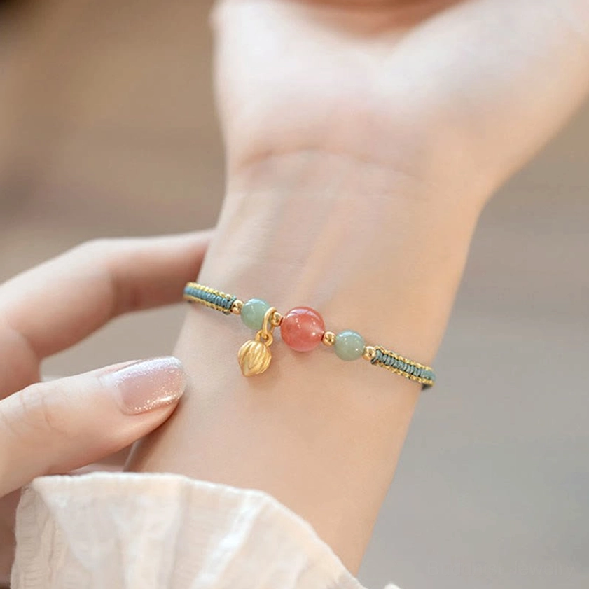 Hand-woven red agate lotus bracelet close-up adjustment showcase on wrist