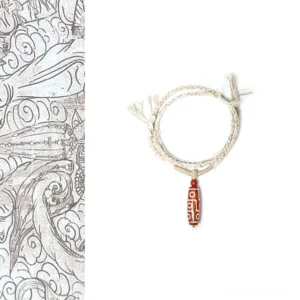 Red agate nine-eye dzi bead buddhist bracelet with white geometric patterns on beige braided rope, traditional spiritual jewelry design