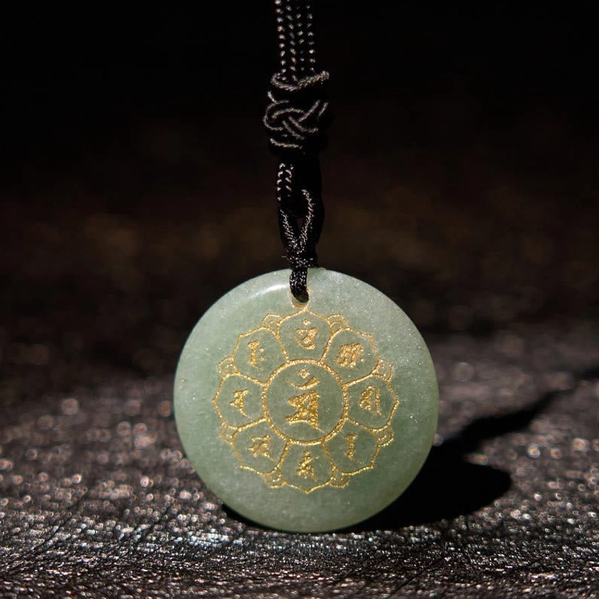 Red Agate Om Mani Padme Hum Buddhist necklace pendant with gold Sanskrit engraving close-up detail