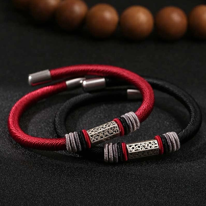 Two red and black cord bracelets with identical engraved silver charms and metal end caps