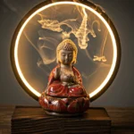 Red glazed Buddhist ceramic backflow incense burner with LED light on wooden table displaying cascading smoke effect