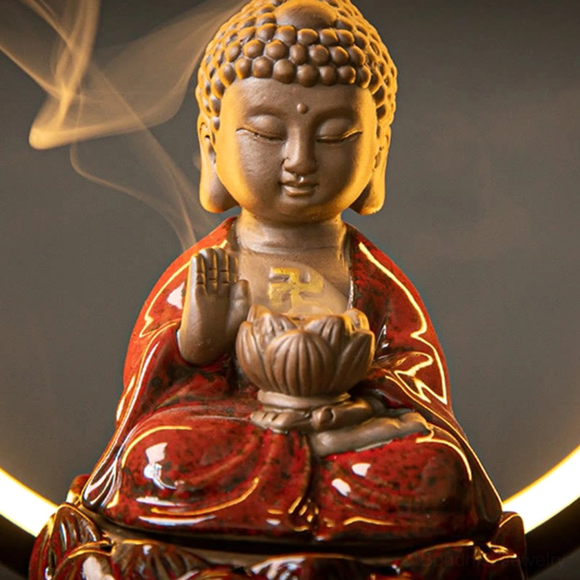 Close-up front view of red Buddhist incense burner showing sacred swastika symbol on chest and lotus-shaped incense vessel
