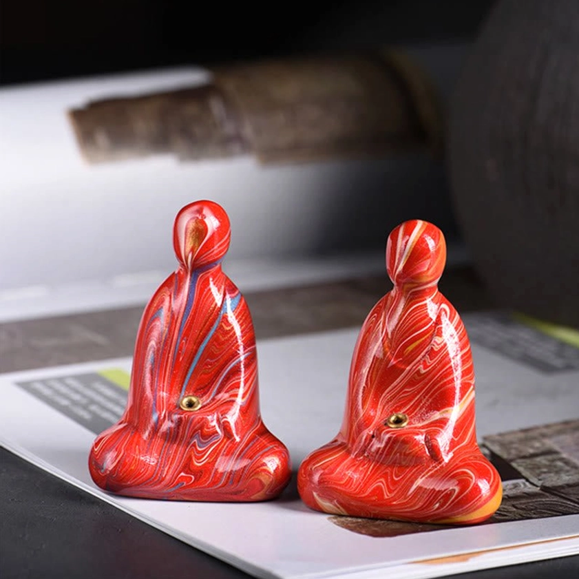 Pair of bright red marbled Buddha incense holders with matching meditation figurine design