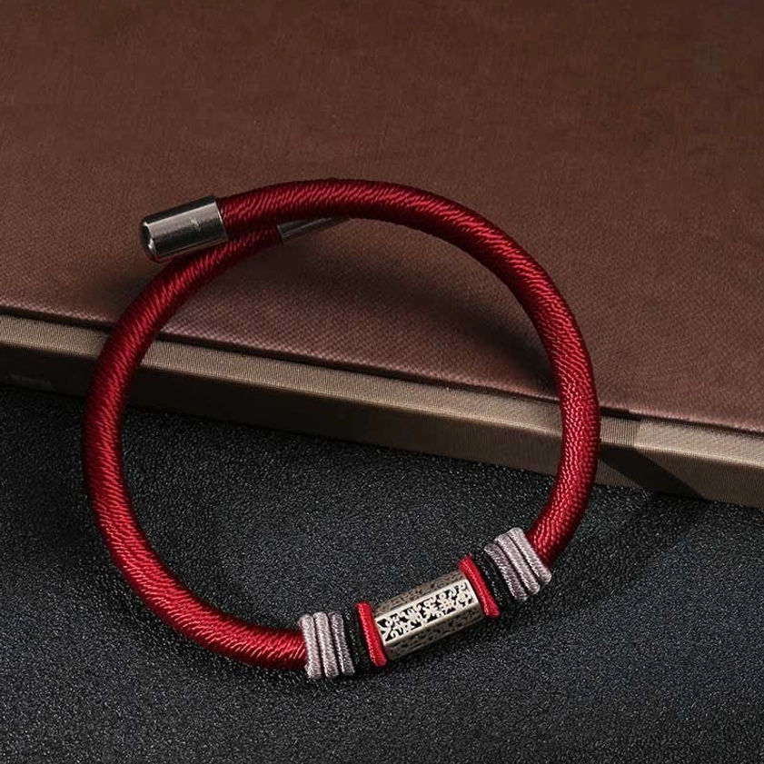 Red cord bracelet on brown leather with silver end caps and engraved Om Mani Padme Hum charm