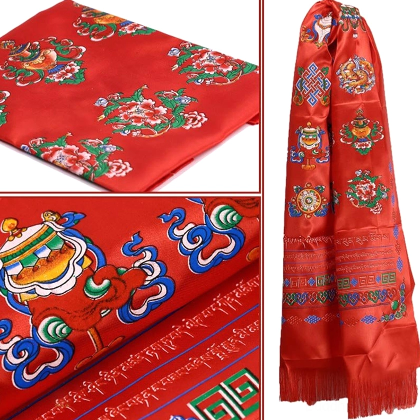 Red Buddhist khata ceremonial scarf with eight auspicious symbols, tasseled hem, and sacred patterns close-up detail