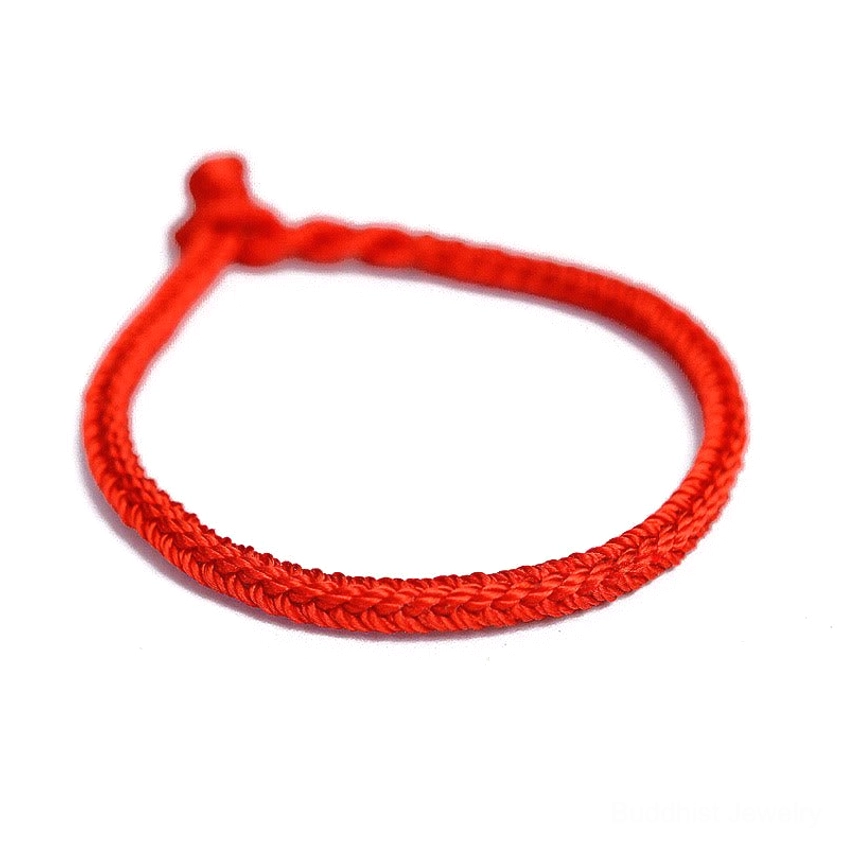 Angled front view of red Buddhist eight-thread braided bracelet showing smooth woven pattern and fixed knot