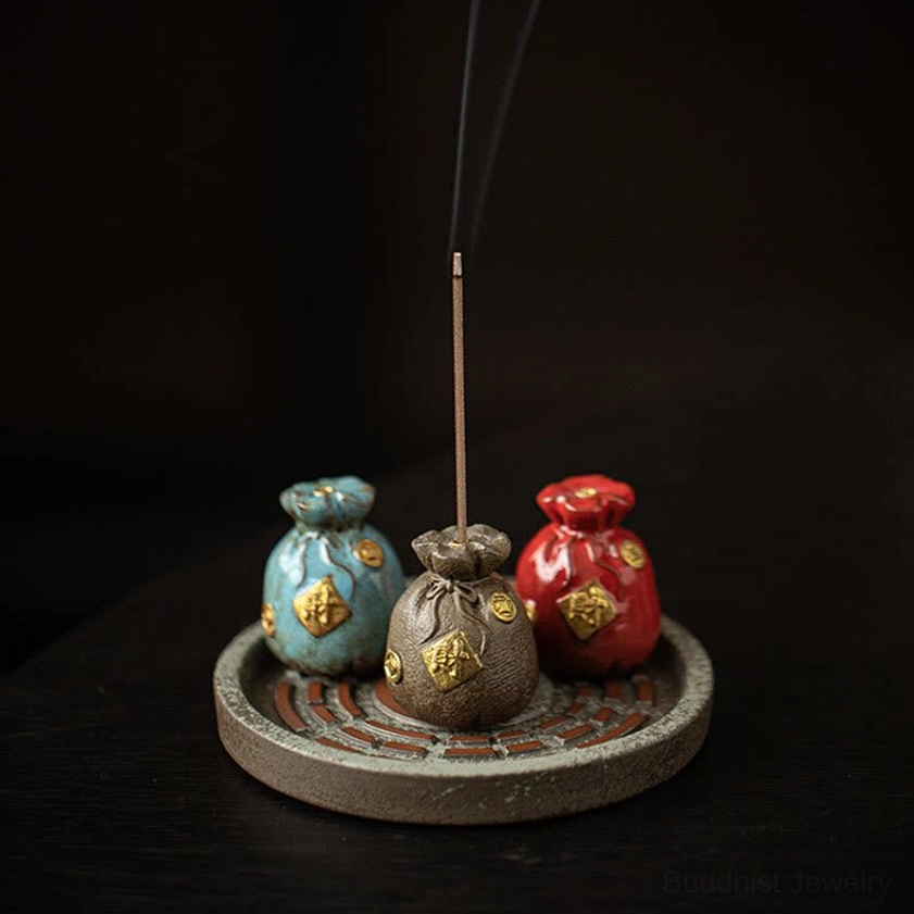 Red ceramic incense burner with Bagua pattern symbolizing balance and positive energy flow in meditation space