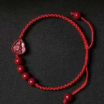 Red cinnabar Buddha blessing bracelet with adjustable red string cord, featuring 6mm round beads and Buddha pendant