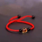 Red citrine black obsidian Buddhist blessing bracelet with King Kong knot, top view showing center citrine and black accent beads
