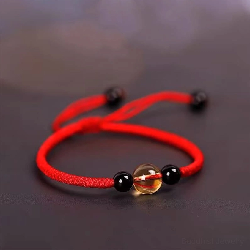 Red citrine black obsidian Buddhist blessing bracelet with King Kong knot, top view showing center citrine and black accent beads