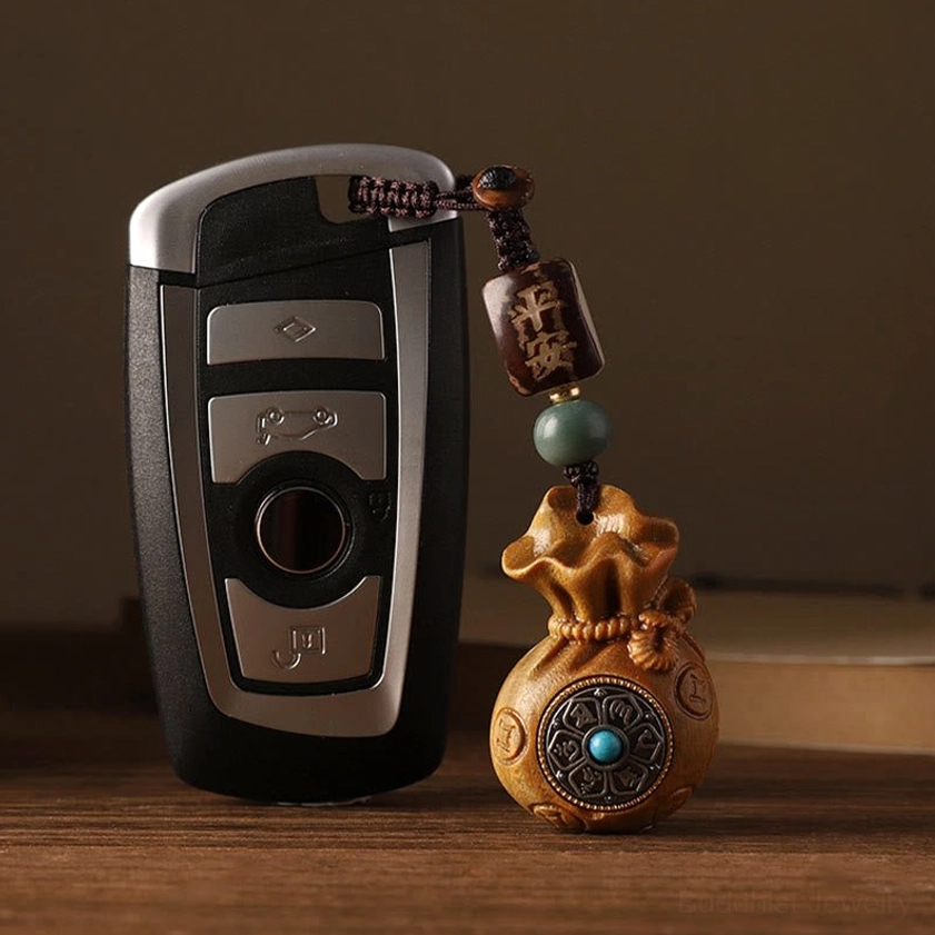Buddhist money bag charm color comparison between red sandalwood and green sandalwood variants for personal protection