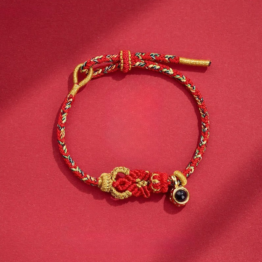 Red hand-woven Buddhist string bracelet with Buddha knot and black bead pendant charm