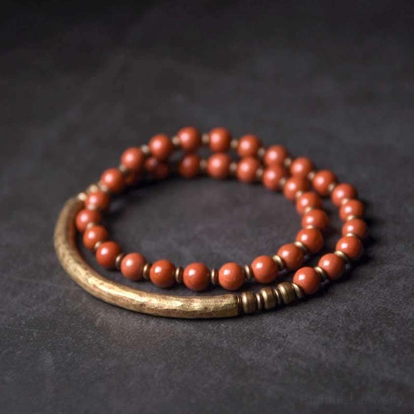Red Jasper and Copper cuff couple bracelet set - flat lay showing two-piece stacked jewelry with reddish brown beads and antique bronze