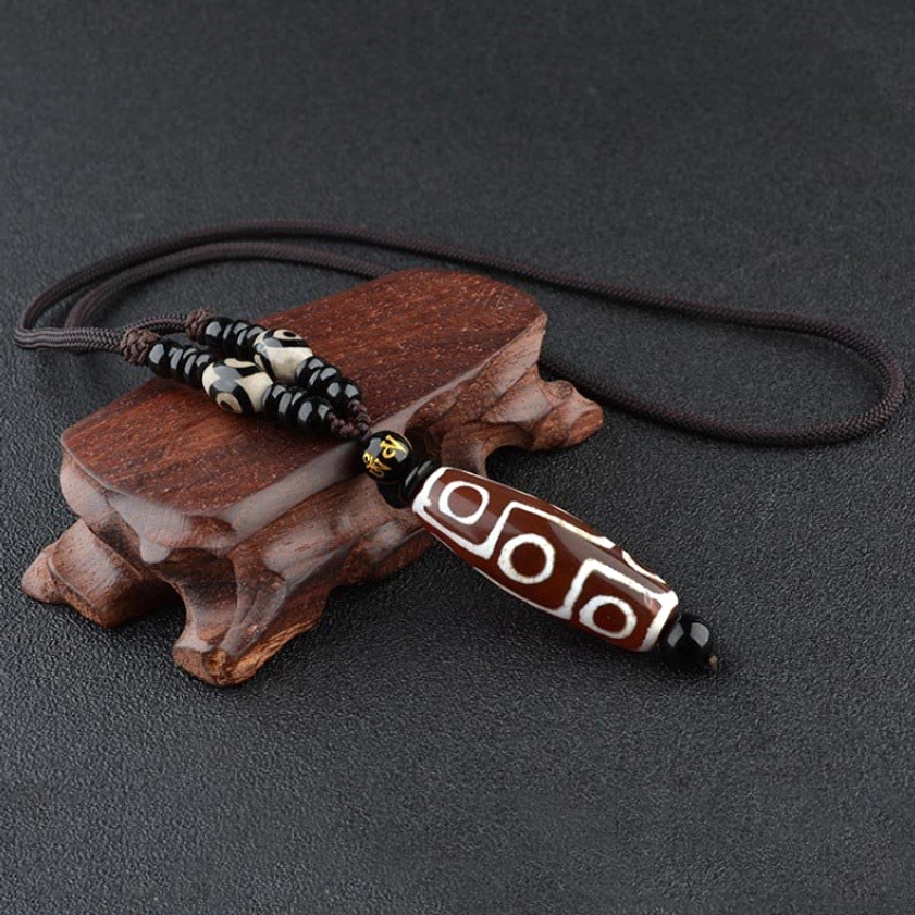 Red nine-eye dzi bead Buddhist pendant with hand-painted cosmic pattern on black woven necklace