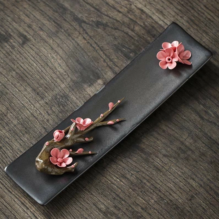 Red plum ceramic incense burner with artistic floral design, meditation room decor