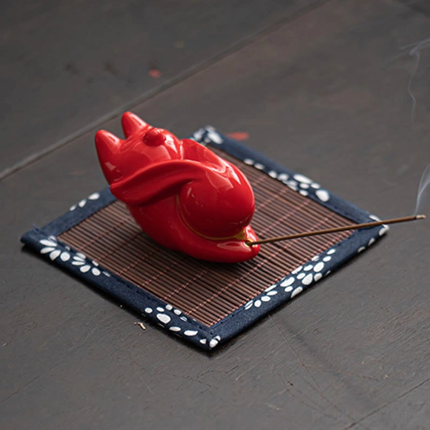 Red ceramic rabbit incense holder detail view showing glazed finish and craftsmanship