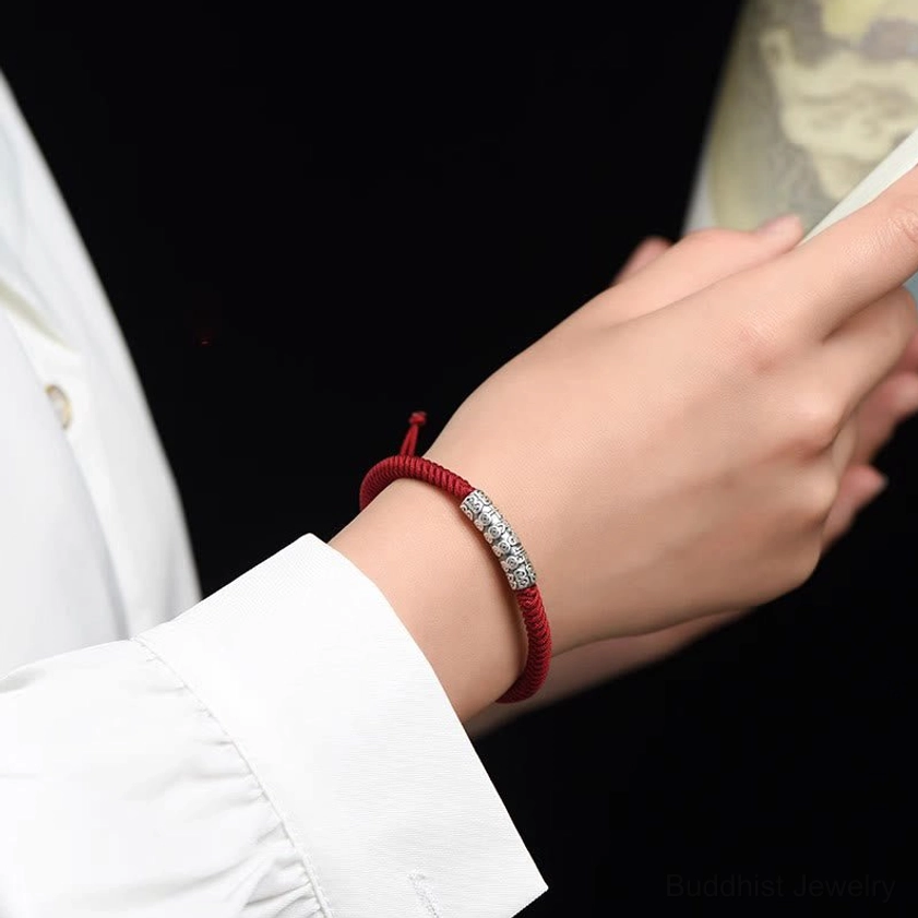 Buddhist string bracelet wearing demonstration on slim wrist showing comfortable fit